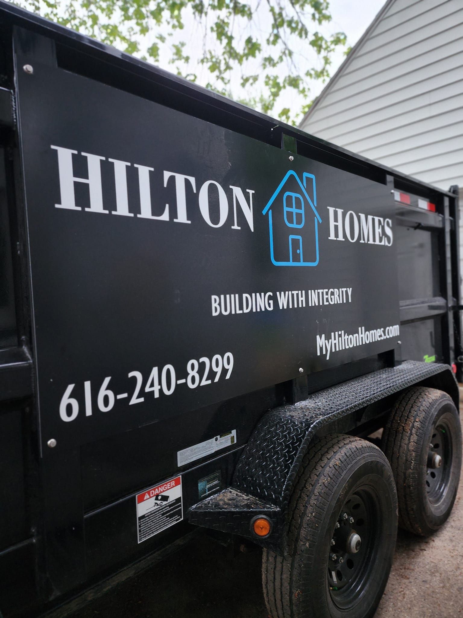 Black trailer with the Hilton Homes logo and contact information.