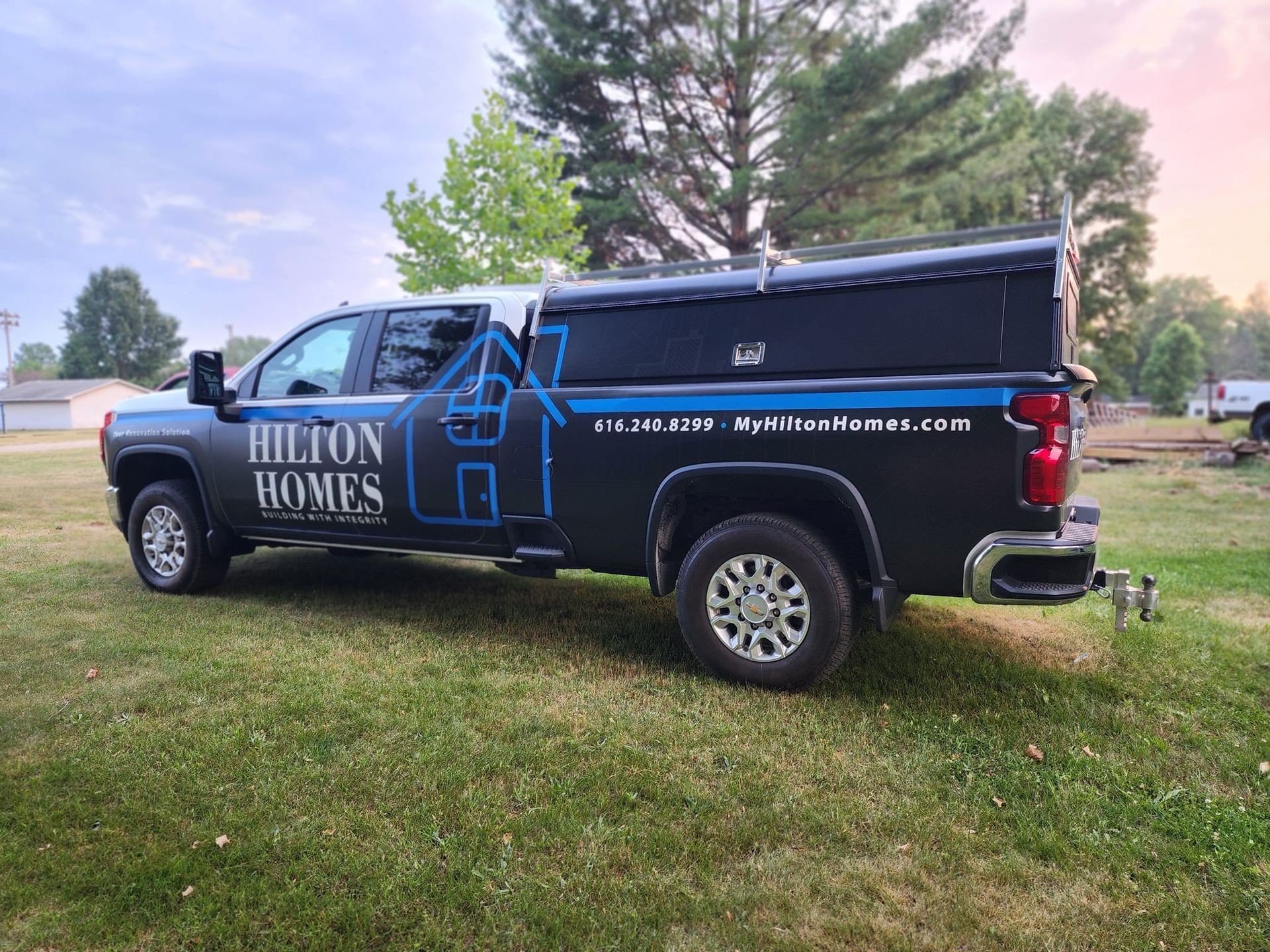Black pickup truck with a blue logo and text for 