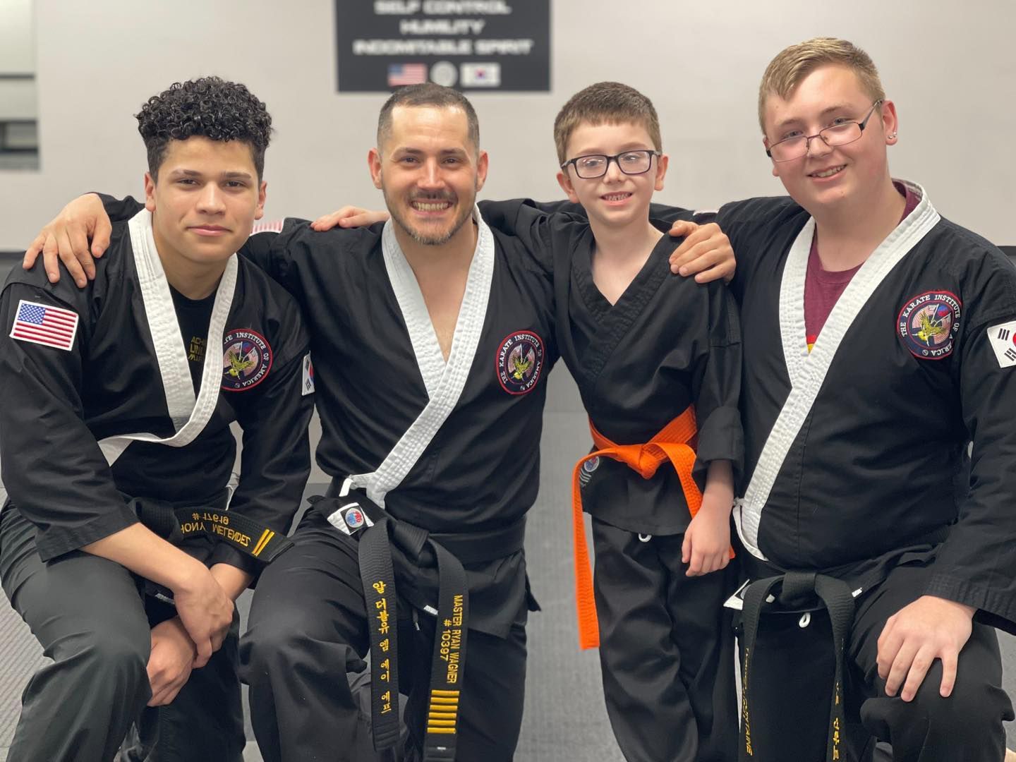 a group of martial arts students pose for a photo