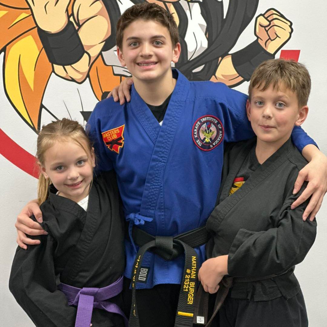a boy in a martial arts uniform has a black belt that says martial super