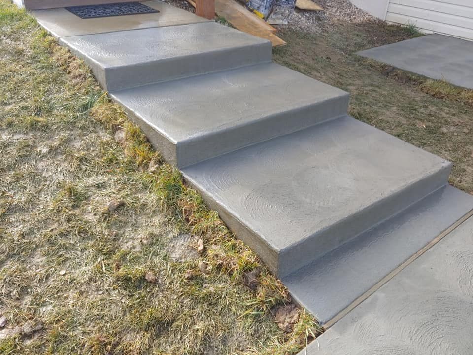 A Man Spreading Concrete - Wentzville, MO - Nelson Concrete & Construction