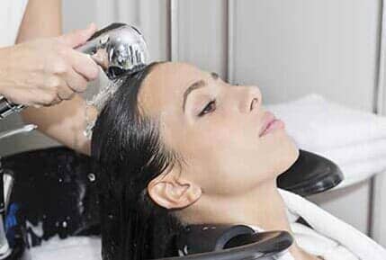 Woman getting hair washed in salon in Lakewood, WA