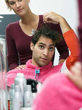 Man instructing stylist on length of desired hair cut in Lakewood, WA