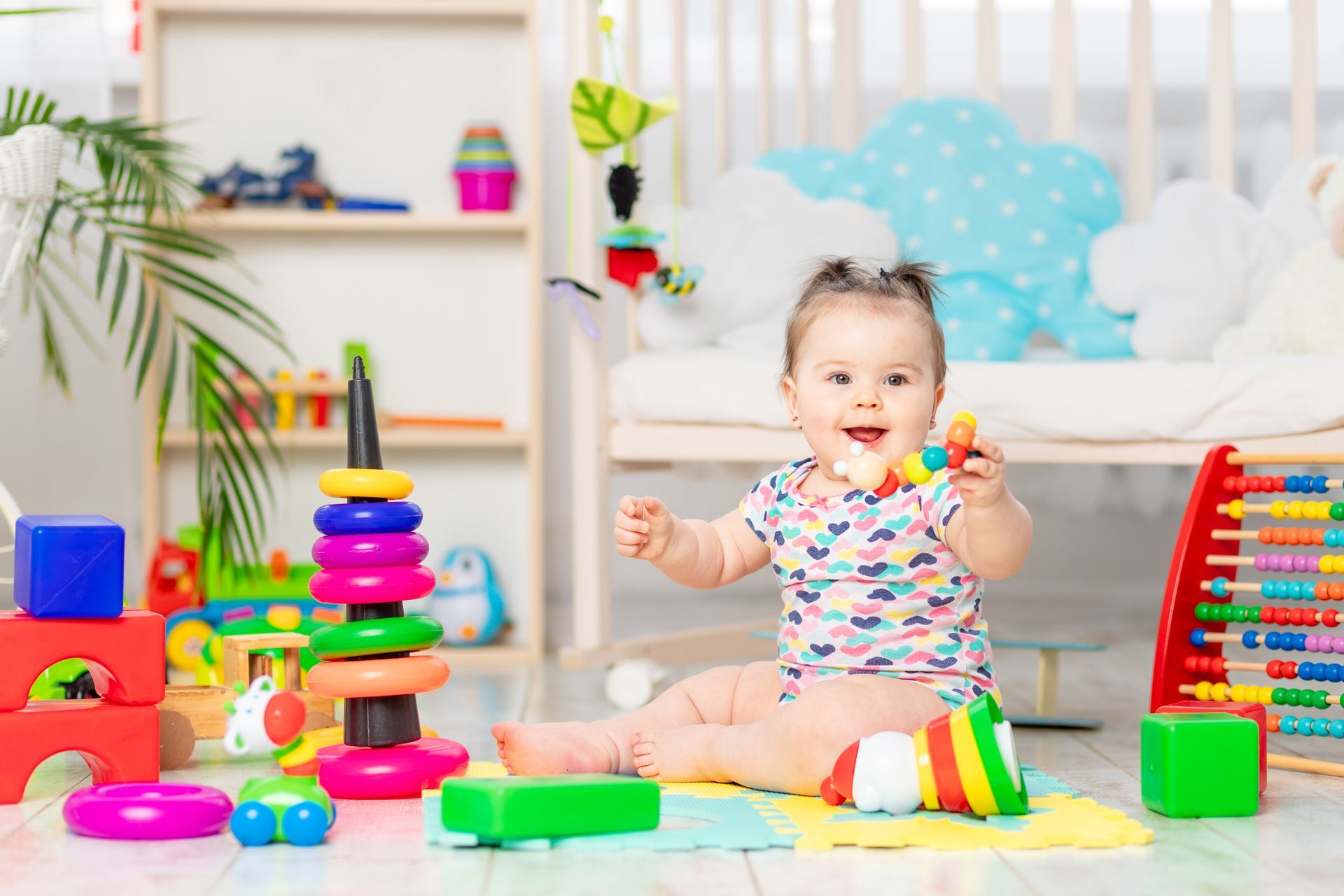 A little girl is playing with blocks on the floor