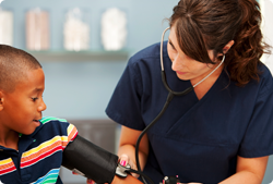 Taking blood pressure of a young boy