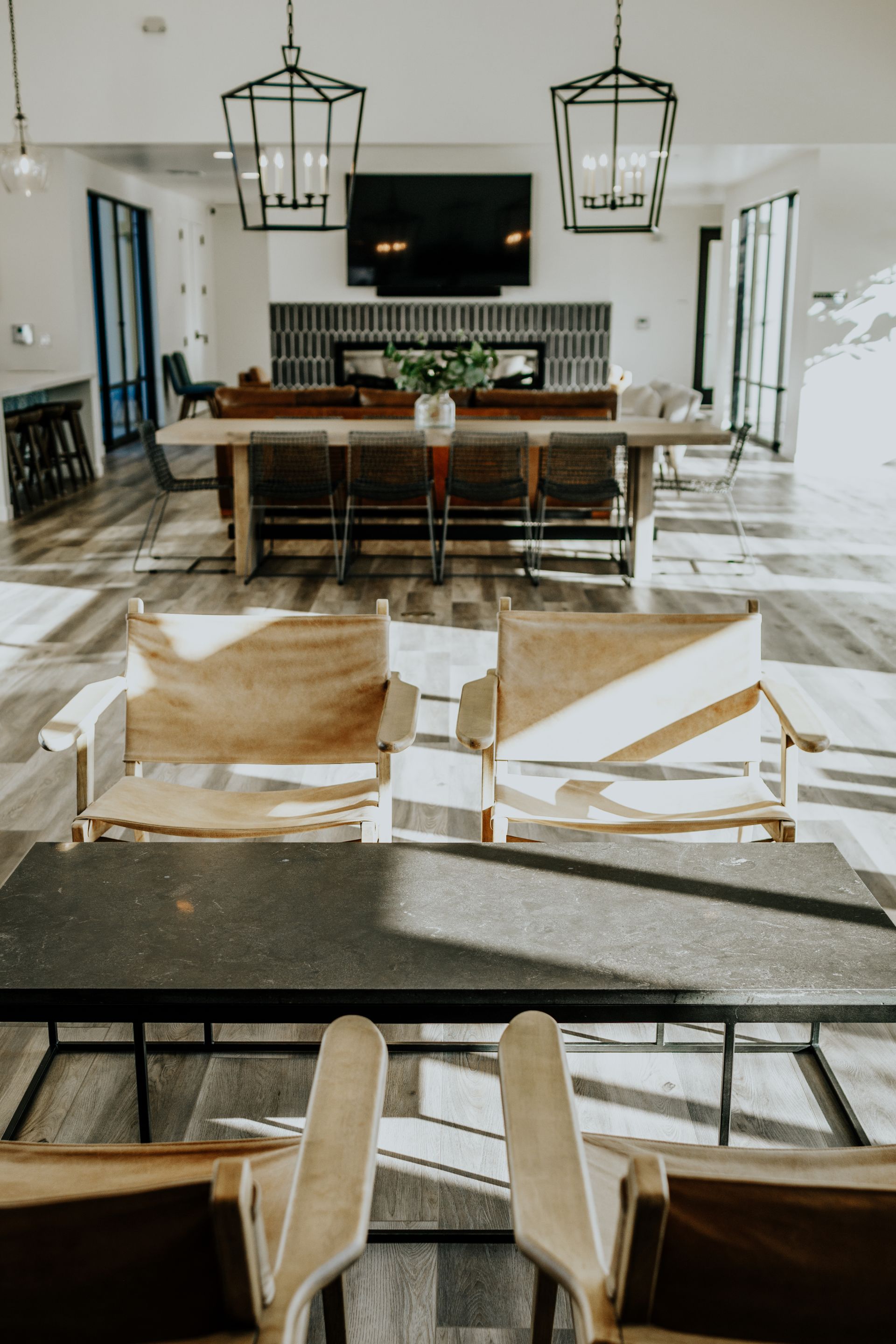 A living room with chairs , a table and a television.