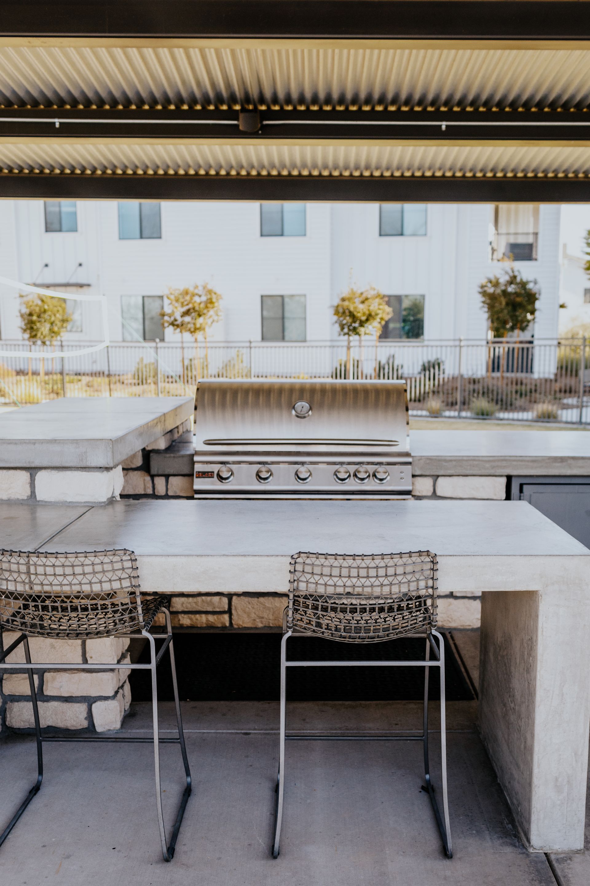 A kitchen with a table and chairs and a grill.