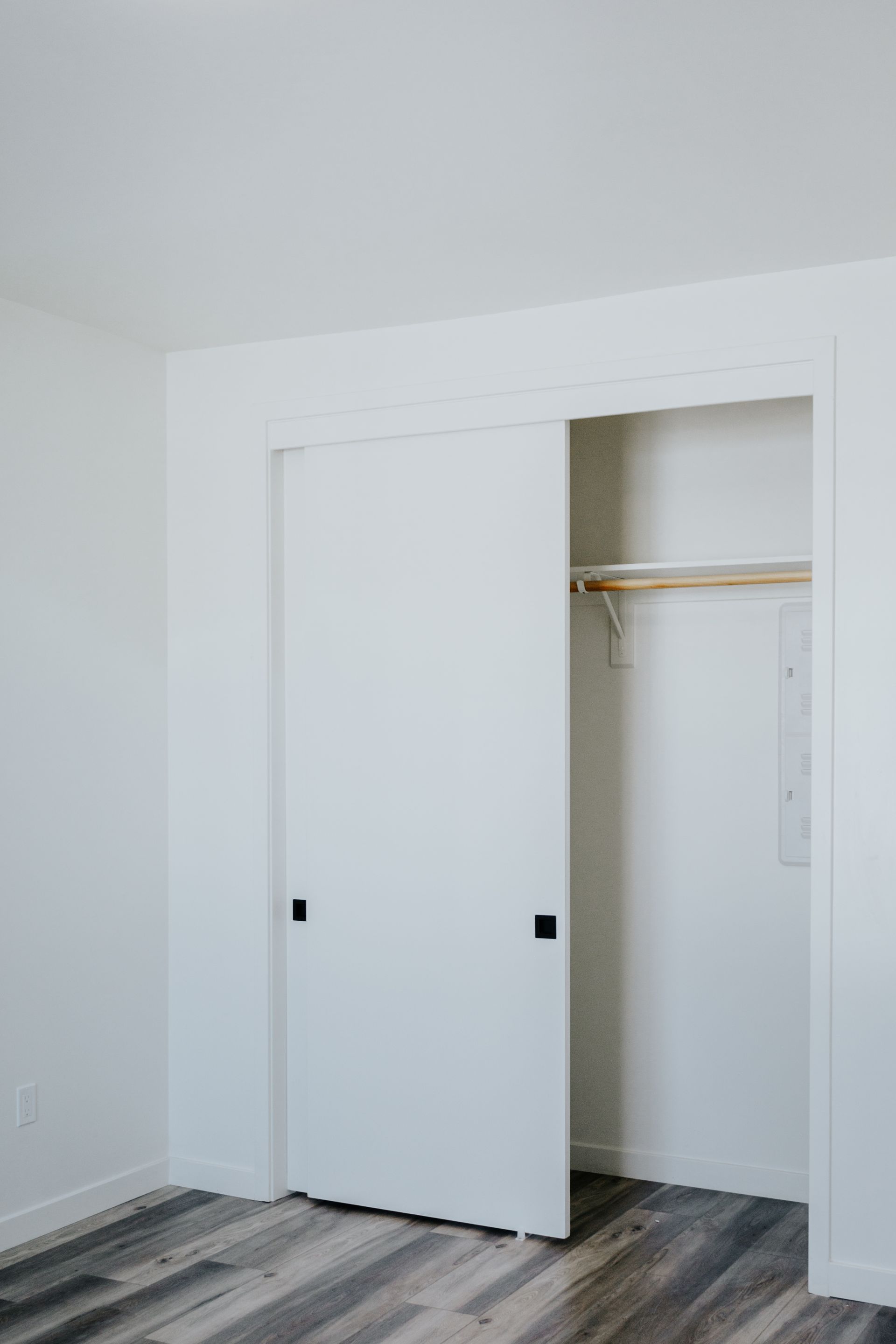 A closet with a sliding door and a shelf in a bedroom.