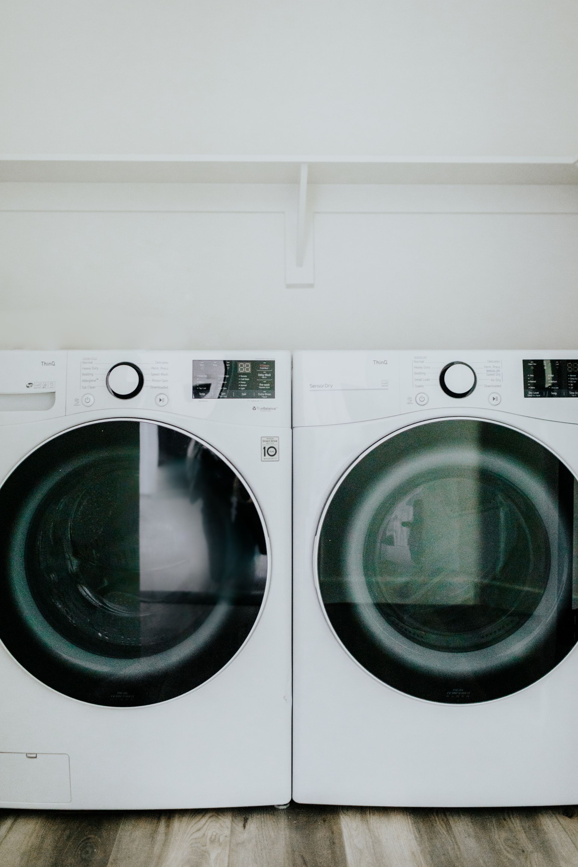 A washer and dryer are sitting next to each other in a laundry room.