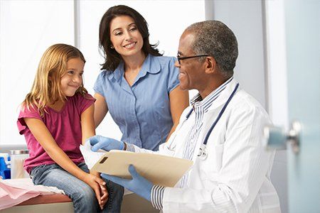 Children's Physician — Doctor Reading Results with Mother and Child in Asheville, NC