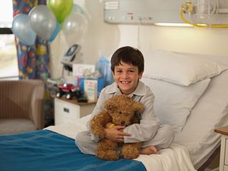 Emergency Care — Boy on Top of Hospital Bed with Teddy Bear in Asheville, NC