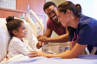 Physicals — Child on Hospital Bed with Father and Nurse in Asheville, NC