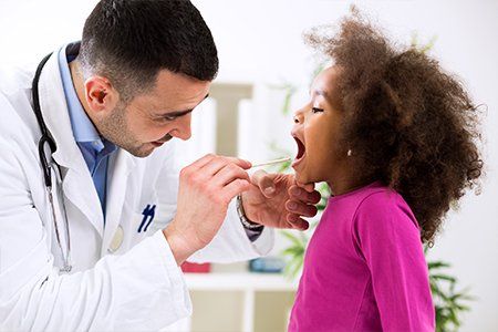 Pediatrics — Doctor Checking Child's Mouth in Asheville, NC
