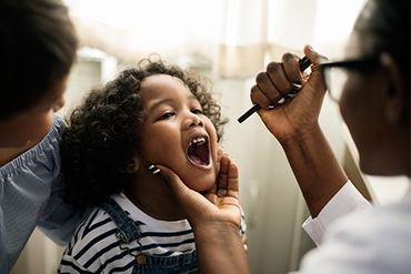 Vaccinations — Doctor Checking Child's Teeth in Asheville, NC
