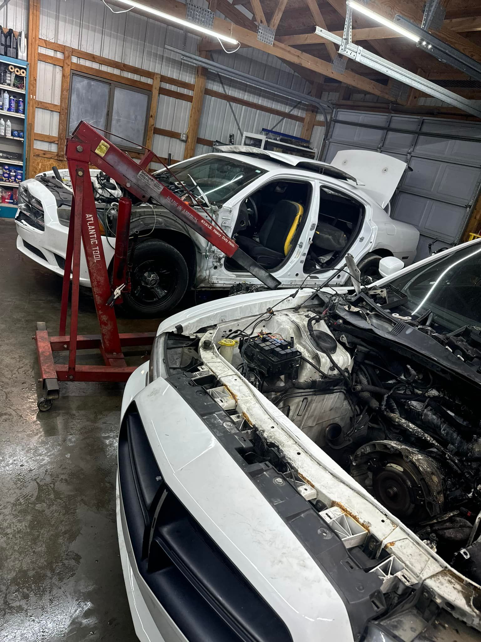 White SUV On Lift With Transmission Removed | Greenfield Auto Repair