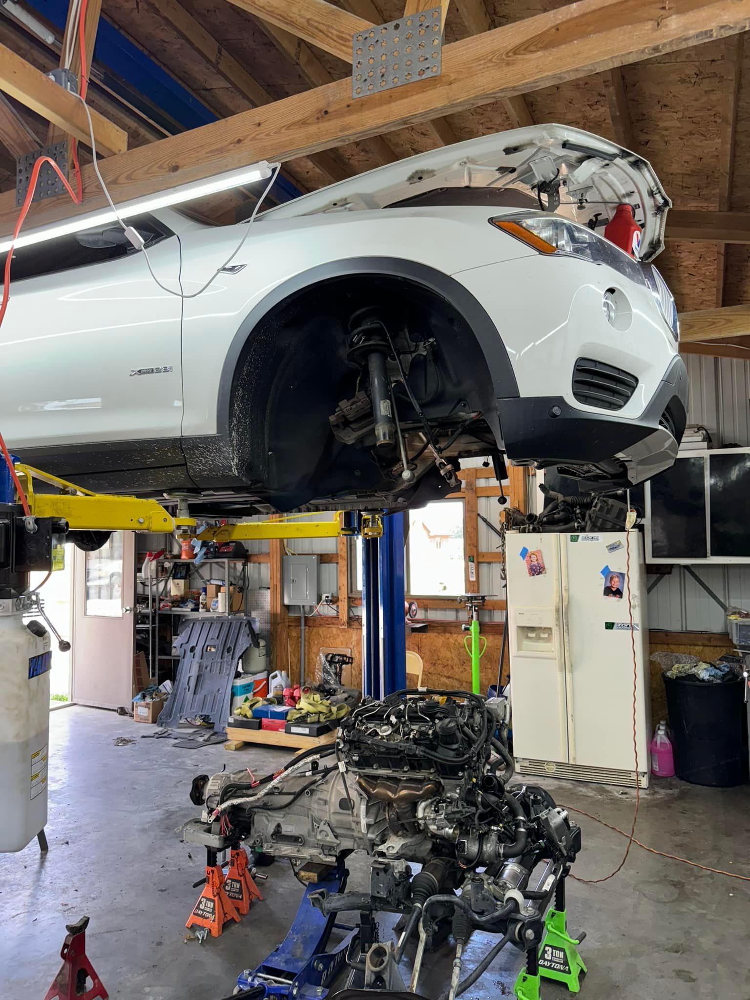 White Pickup In Shop Undergoing Engine Repair | Greenfield Auto Repair