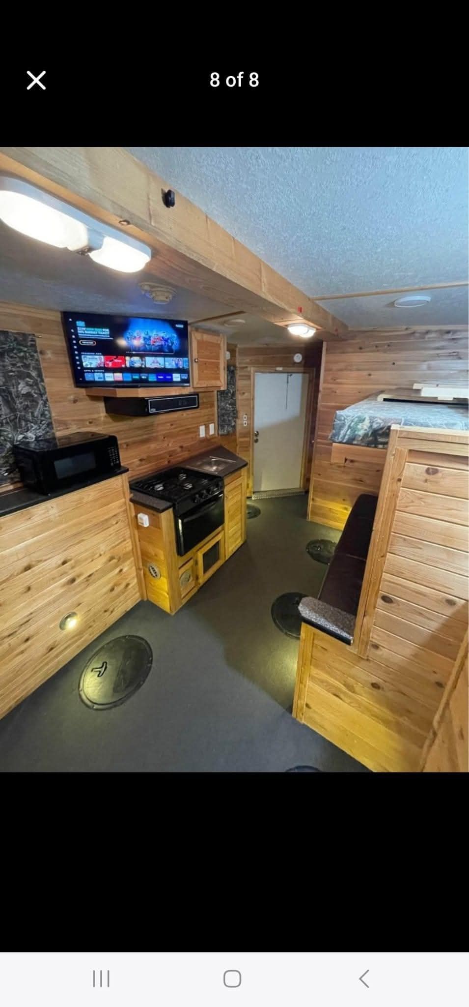 A picture of a room with a television on the wall.