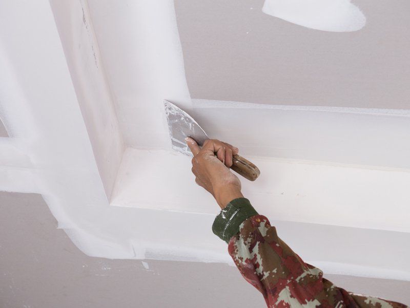 Worker Using Gypsum Plaster on Ceiling — Birmingham, AL — Jordan & Associates
