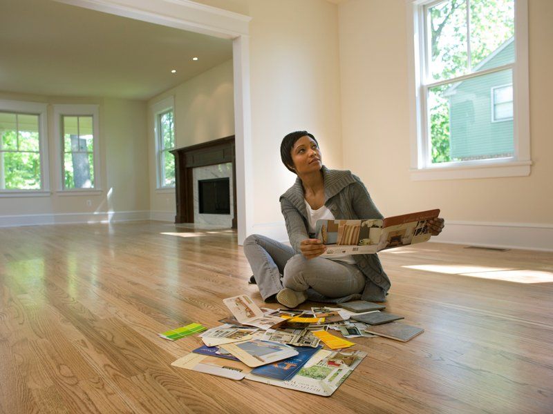 Woman Looking at Paint Samples in Room — Birmingham, AL — Jordan & Associates