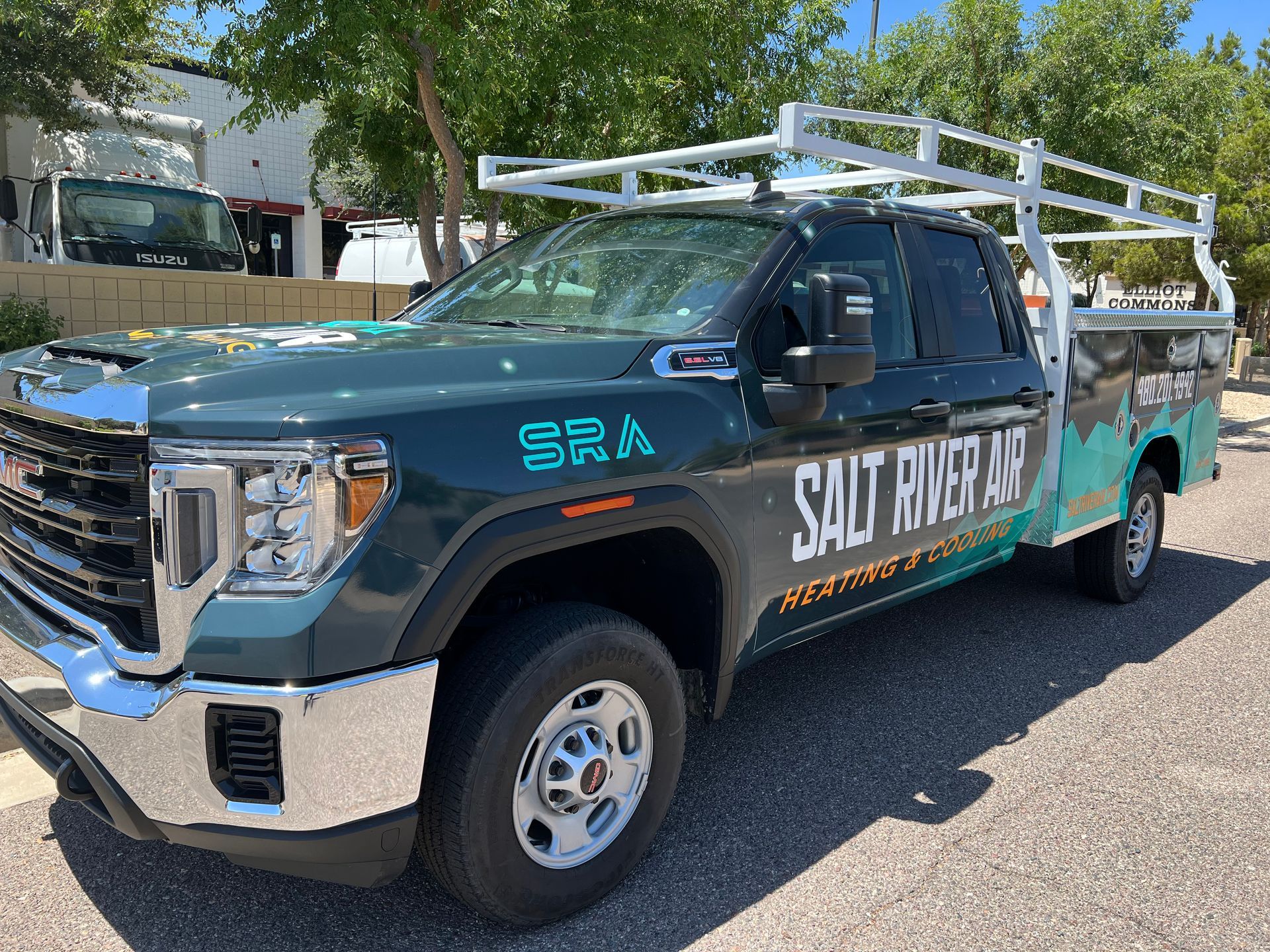 A salt river asphalt truck is parked on the side of the road.