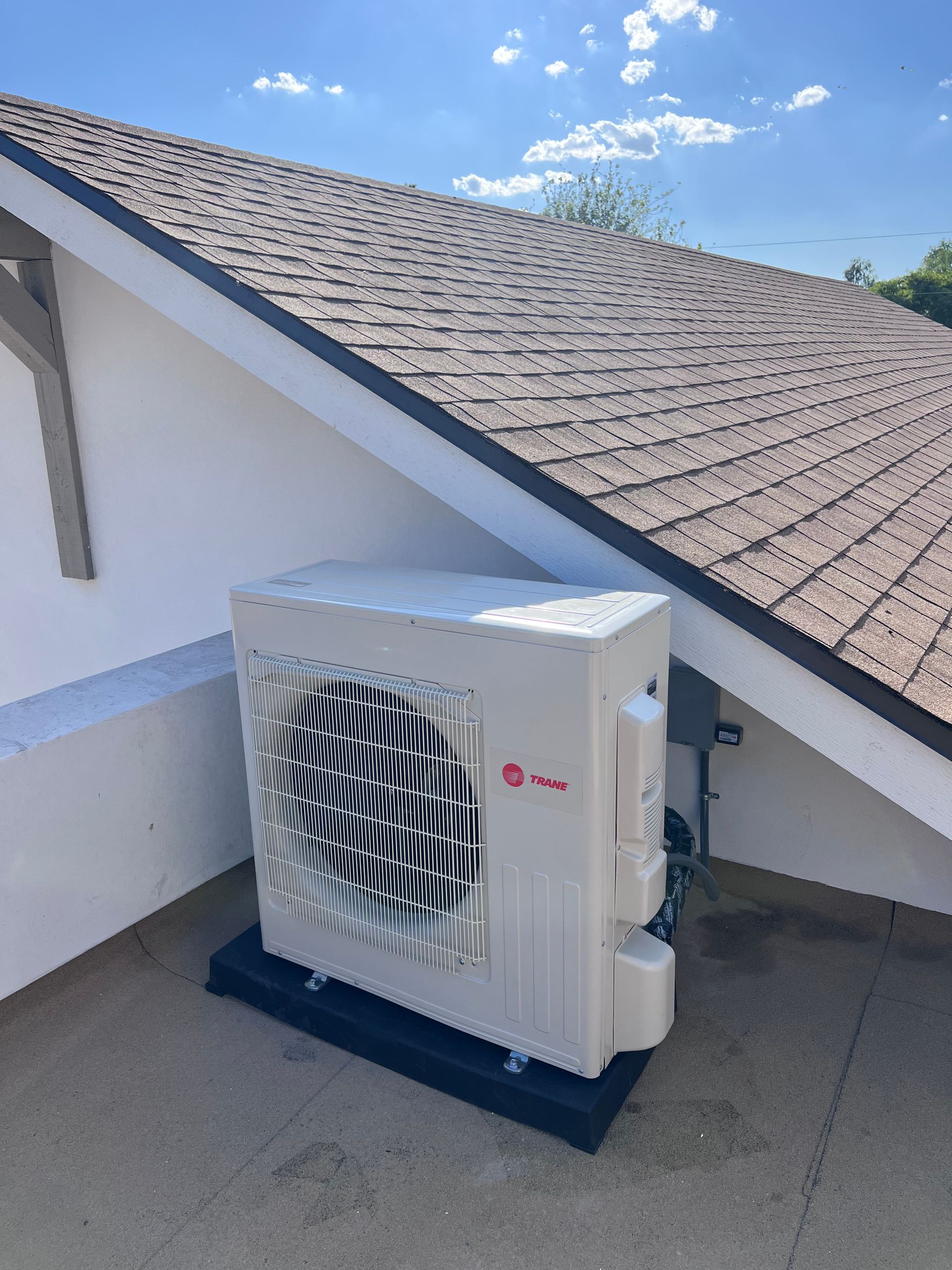An lg air conditioner is sitting on top of a roof.