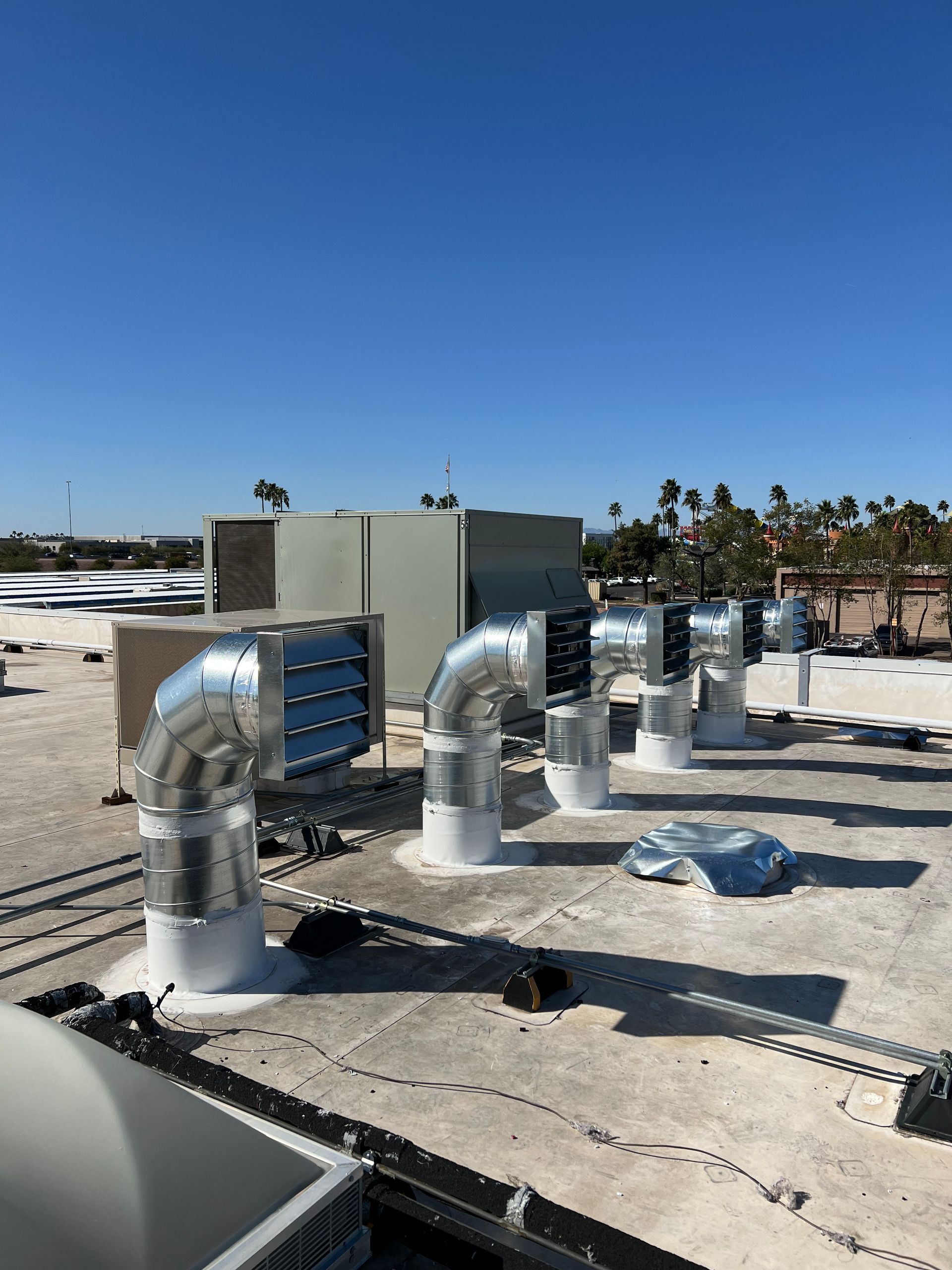 A row of ducts on the roof of a building.