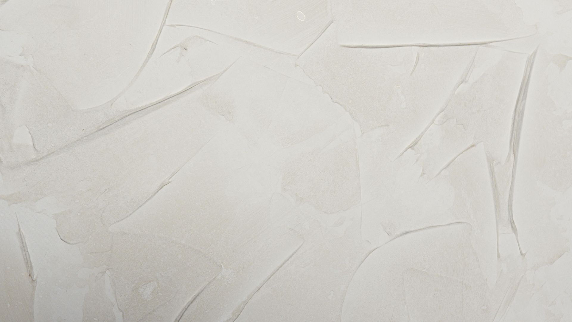 Textured off-white wall with visible brushstrokes.