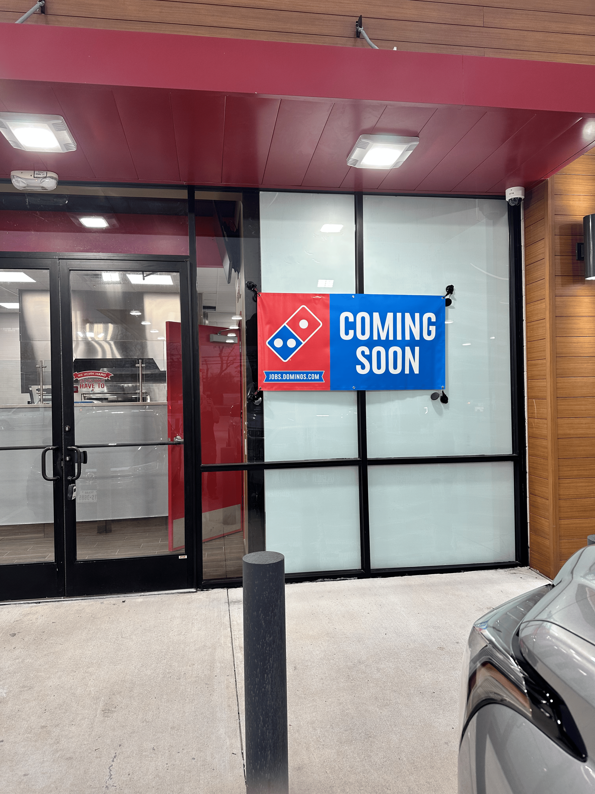 A domino 's pizza restaurant with a sign that says coming soon