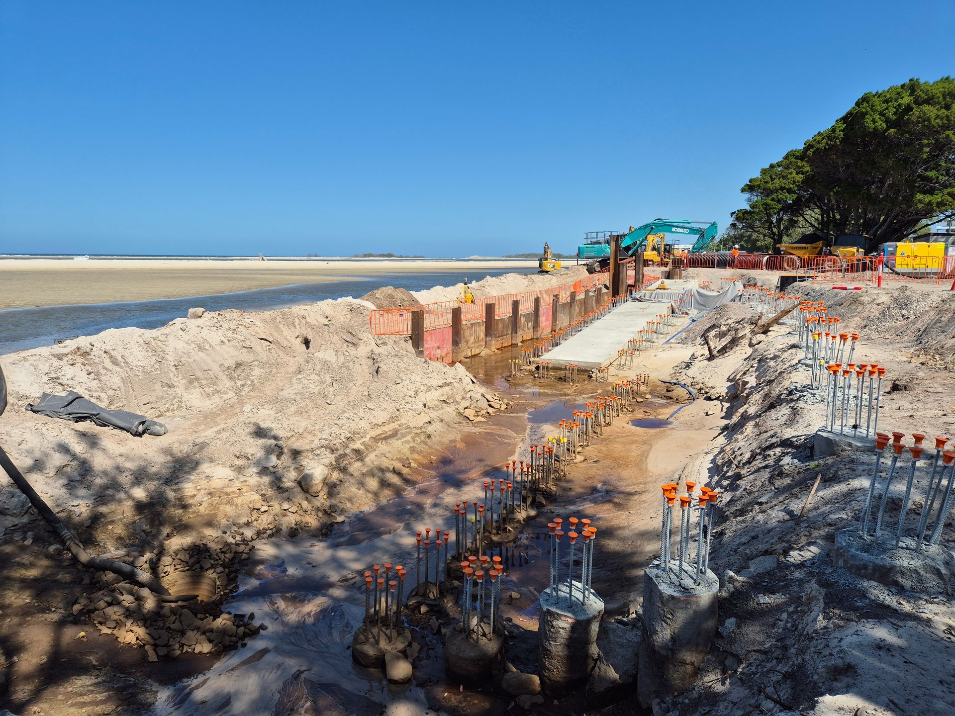 Beach Construction Site With Exposed Supports — Next Step Surveying in Caboolture, QLD