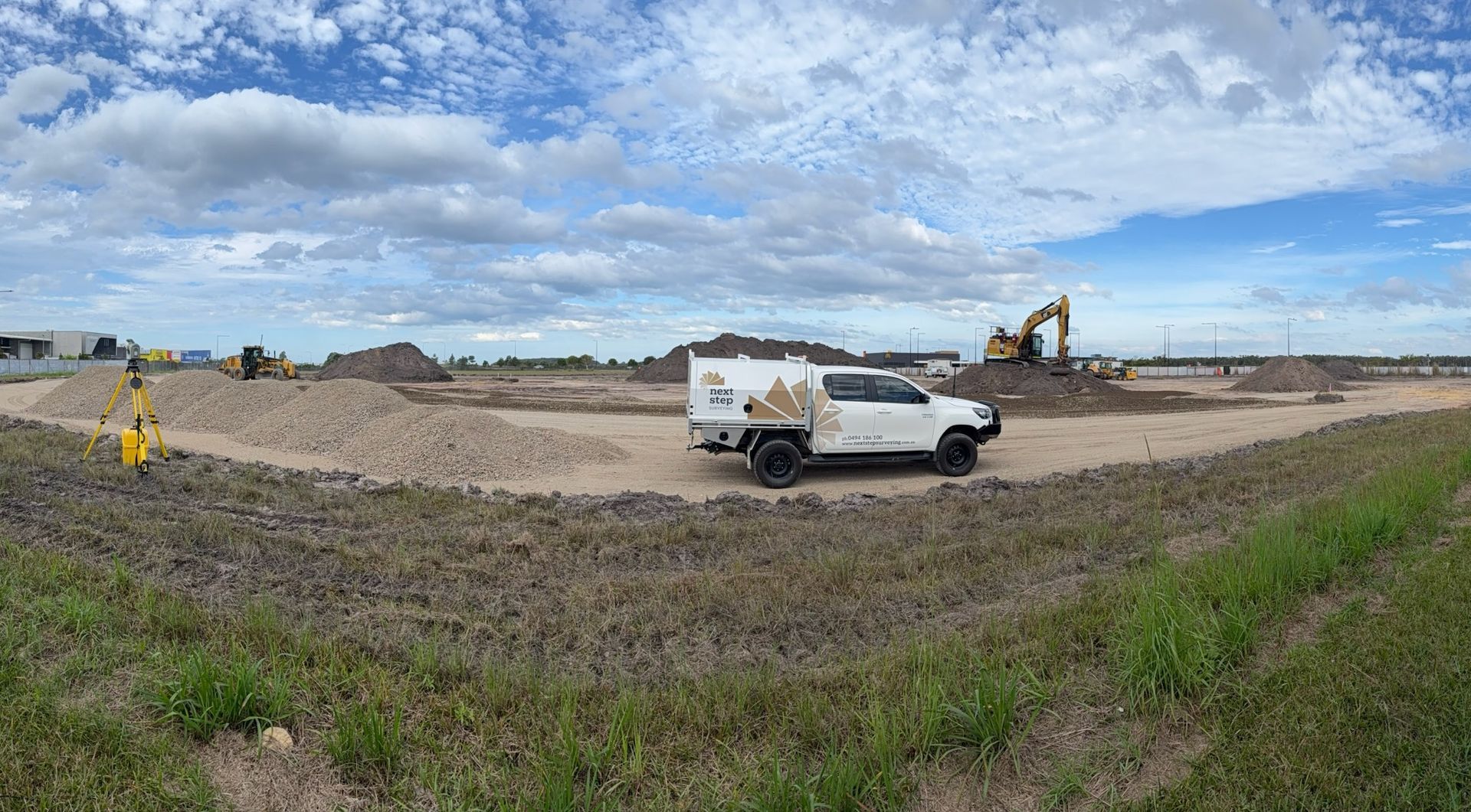 Construction Site With a White Truck, Excavators — Next Step Surveying in Brisbane, QLD