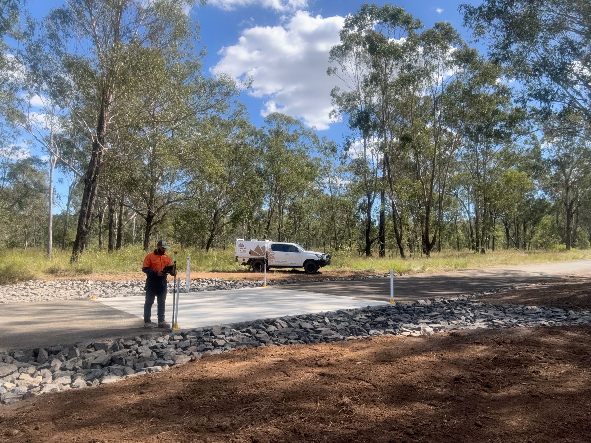Man Standing Near Concrete Construction — Next Step Surveying in Brisbane, QLD