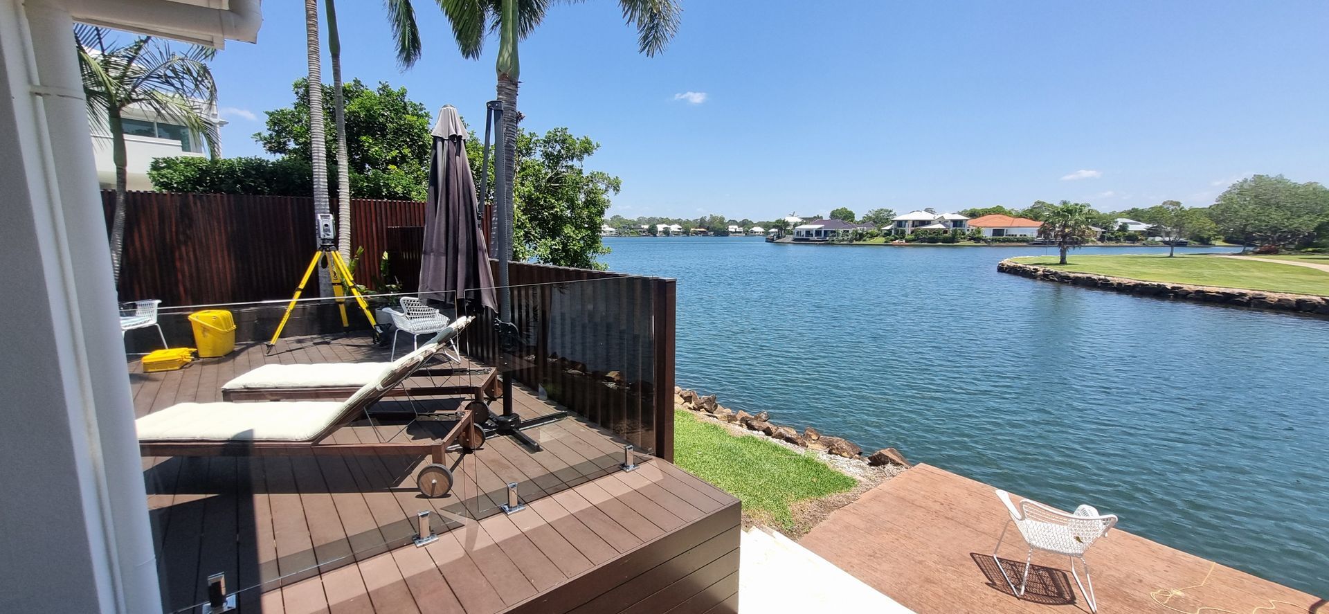 Deck Overlooking a Blue Waterway With Houses — Next Step Surveying in Gympie, QLD