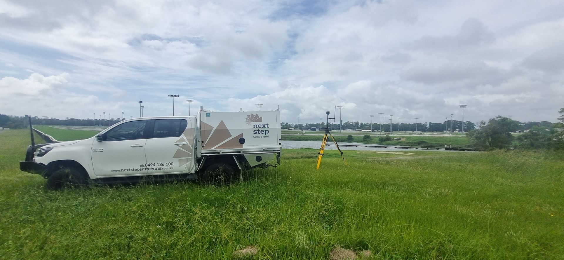 White Truck Parked in a Grassy Field — Next Step Surveying in Coolum, QLD