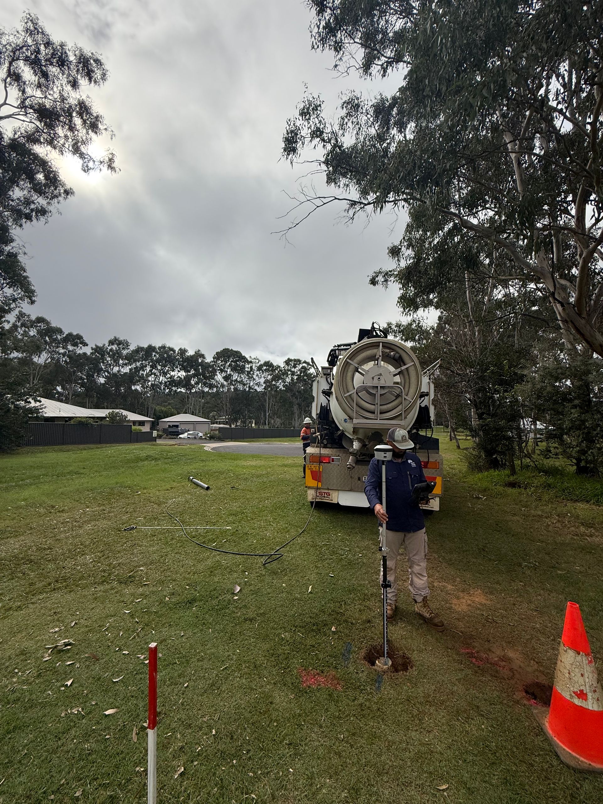 Person Surveying on a Grassy Lot With a Large Truck — Next Step Surveying in Kawana, QLD