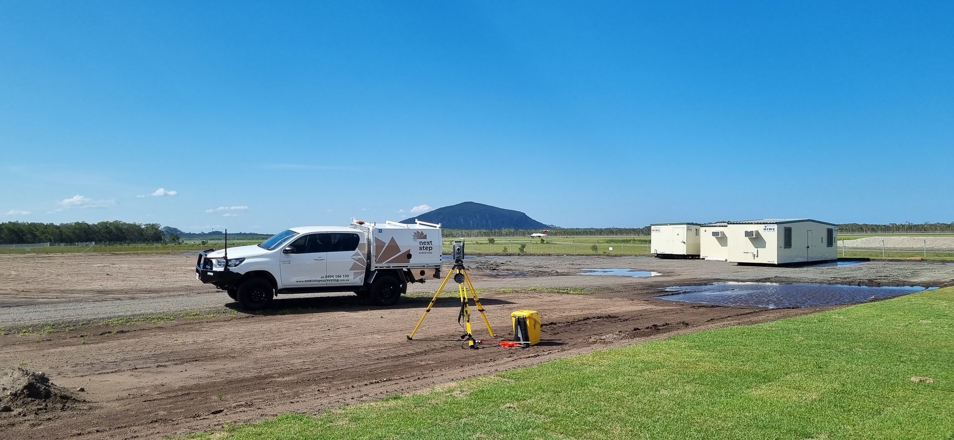 White Truck and Surveying Equipment on a Muddy Field — Next Step Surveying in Coolum, QLD