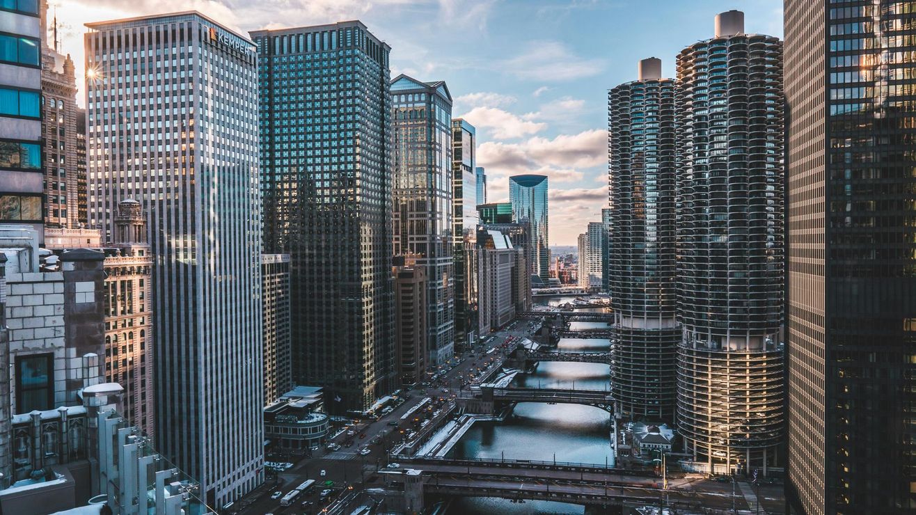 An aerial view of a city with lots of tall buildings and a river.