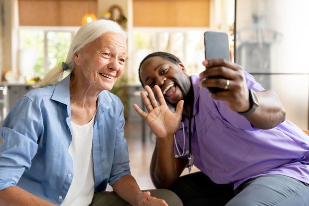 A man is taking a selfie with an elderly woman.