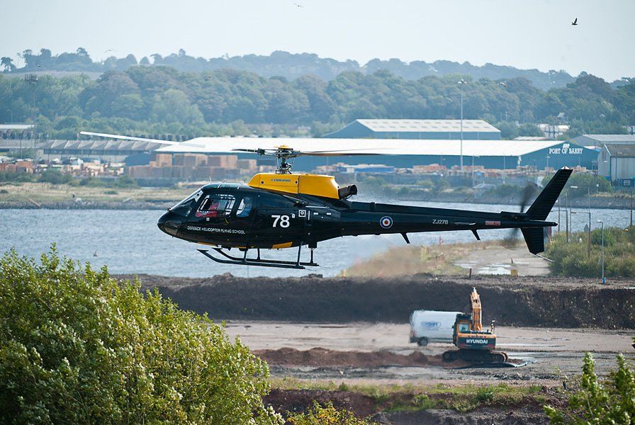 Defence Helicopter Flying School land at Barry Island for the Red Arrows Display Team event.