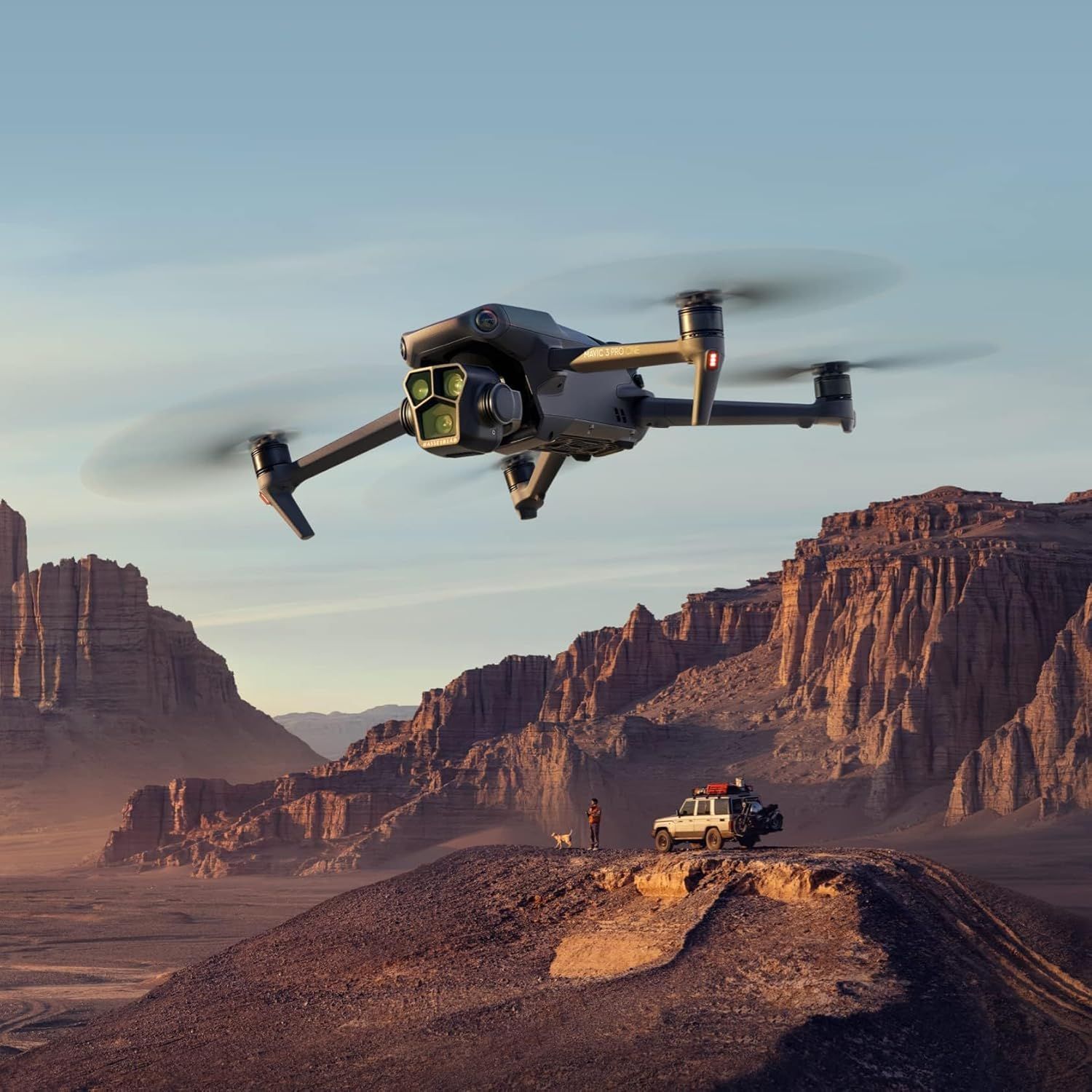 A DJI Mavic 3 Pro Cine drone is flying over a desert landscape