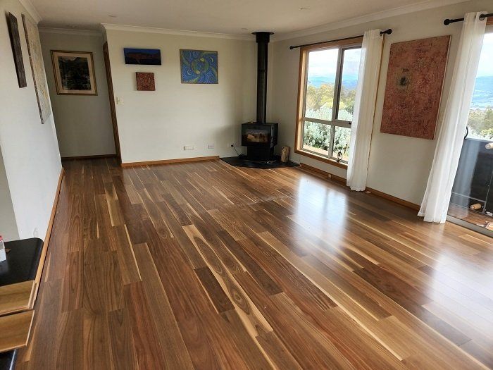 A living room with hardwood floors and a fireplace