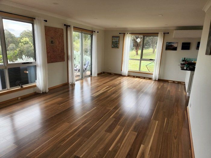 A living room with hardwood floors and sliding glass doors.