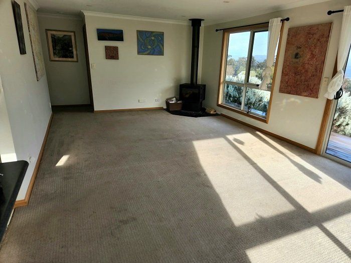 A living room with a fireplace and a lot of windows