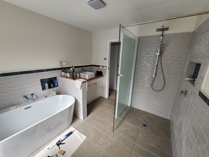 A bathroom with a bathtub and a walk in shower.