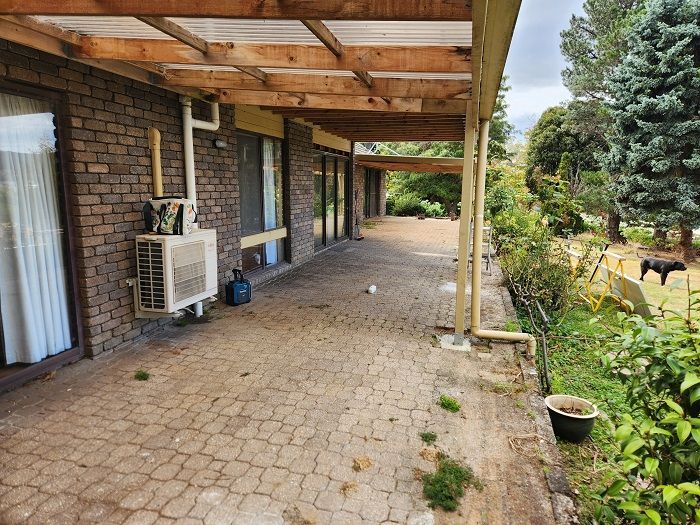 A brick house with a covered patio and a pergola.