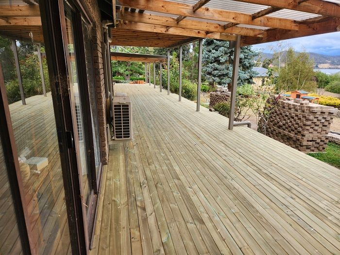 A large wooden deck with a canopy over it