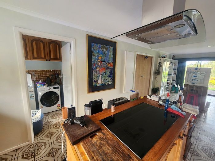 A kitchen with a large island and a stove top oven.