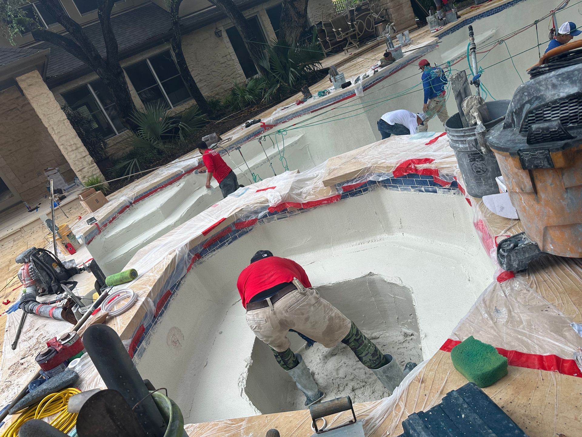 A group of people are working on a swimming pool.