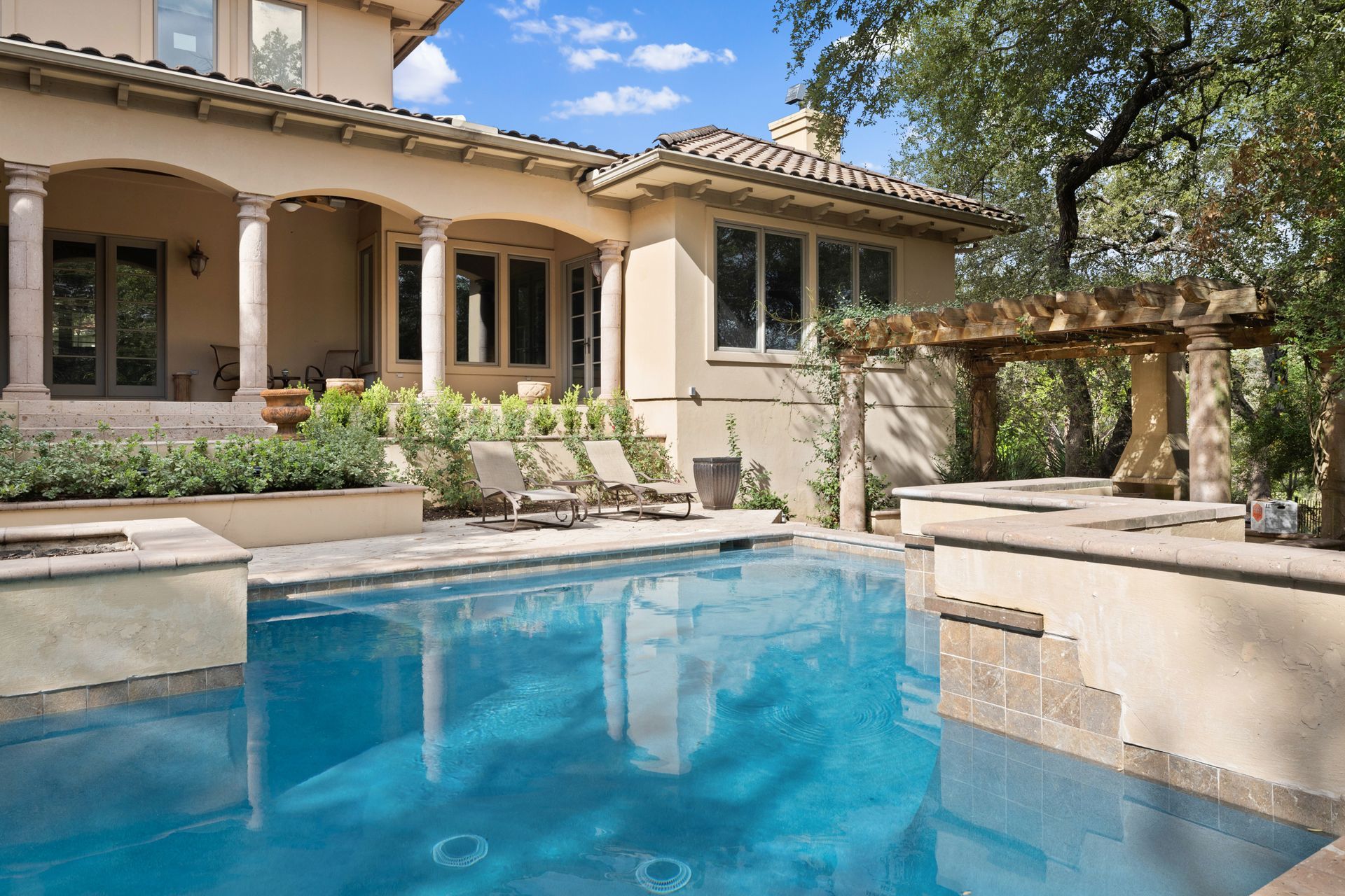 A large house with a large swimming pool in front of it