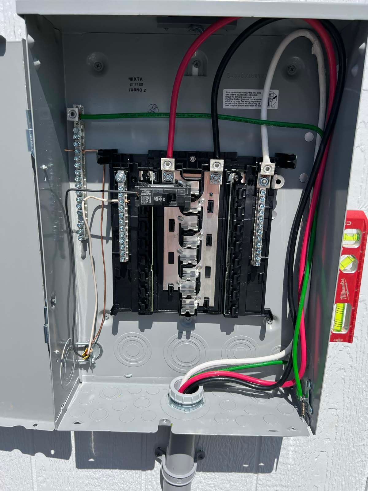 A close up of an electrical box with wires coming out of it.
