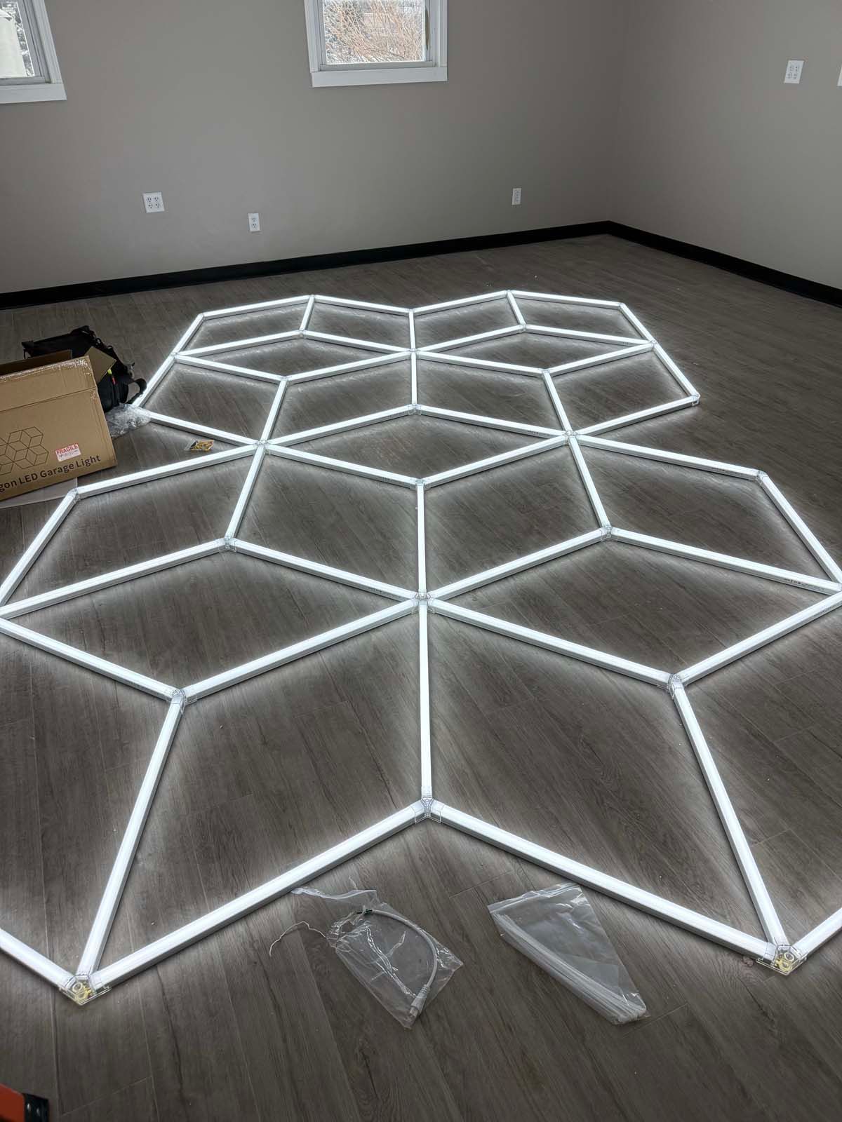 A room with a geometric pattern of lights on the floor.